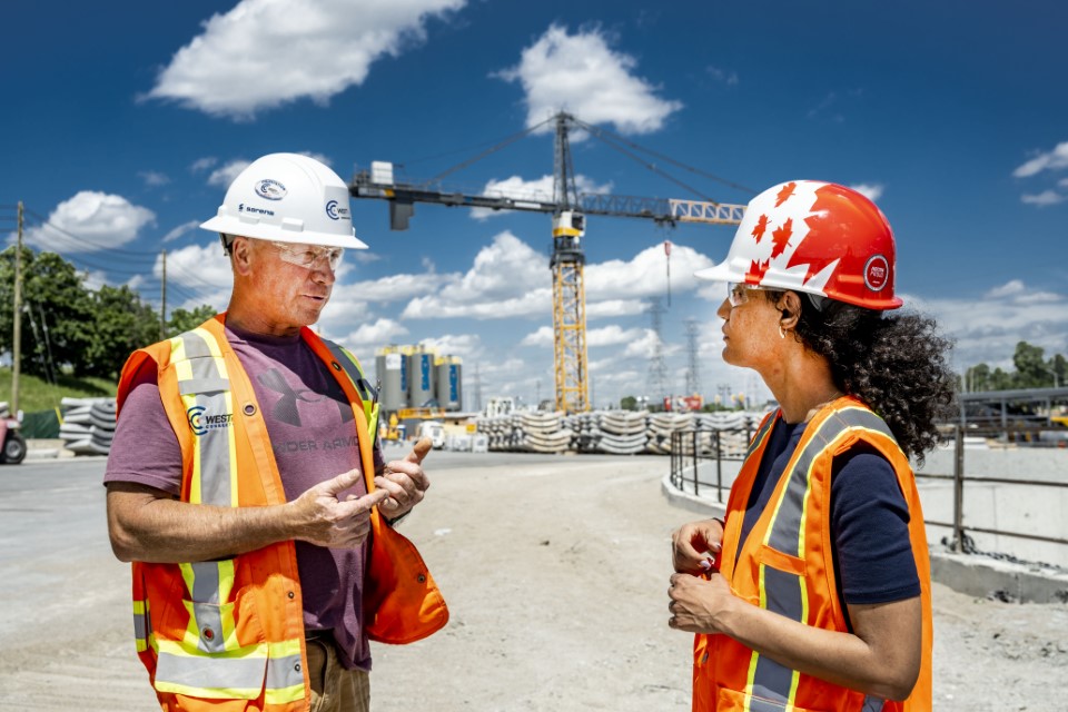 Two construction professionals talking on a construction site