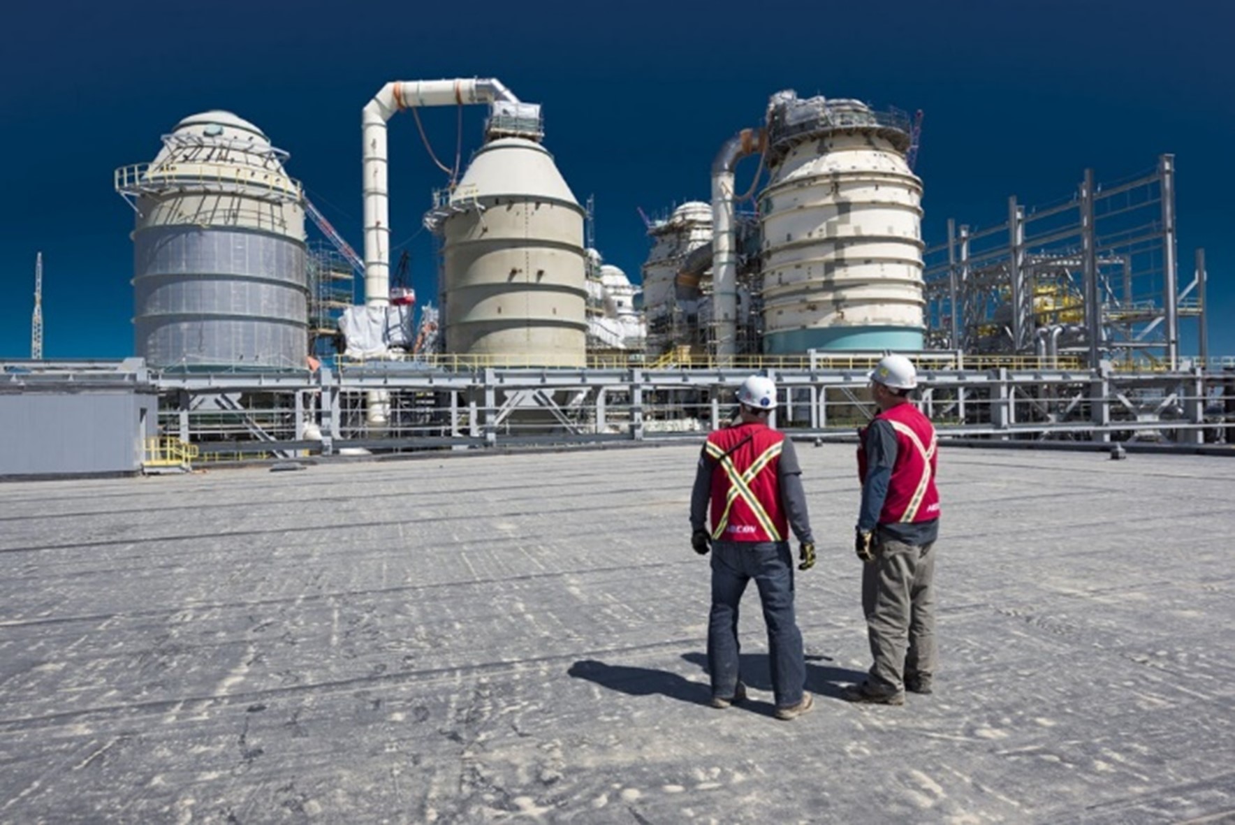 Two Aecon workers talking on site